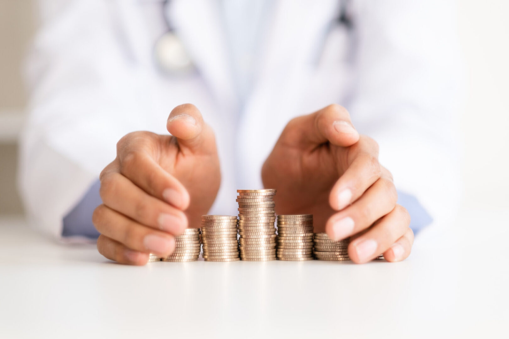 Physician handling stacks of coins