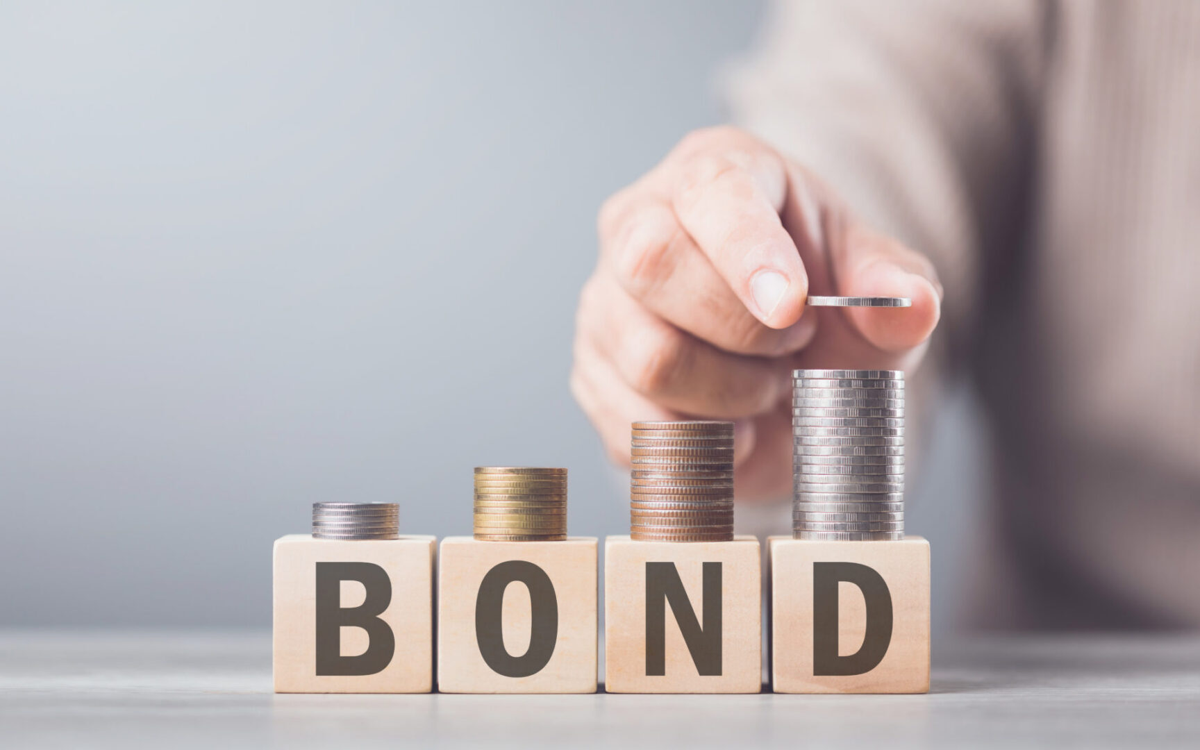 Coins increasing on bond wooden blocks