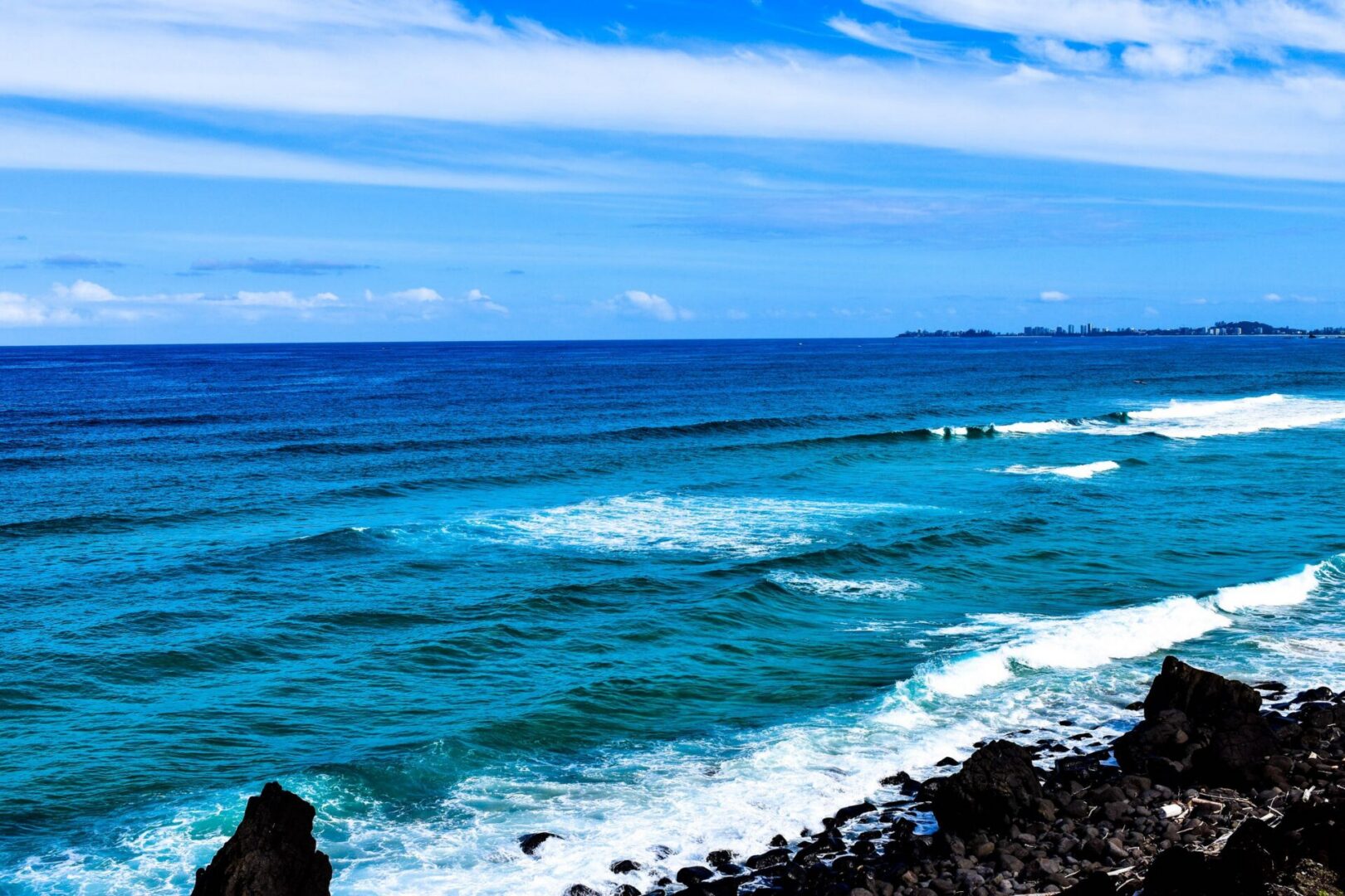 Scenic ocean landscape with black rocks